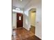 Welcoming entryway featuring wood door, tile flooring, and an arched doorway leading into the home at 8536 W Rockwood Dr, Peoria, AZ 85382