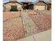 Inviting front exterior with a brick walkway leading to the entrance and well-maintained landscaping with decorative rock at 8536 W Rockwood Dr, Peoria, AZ 85382