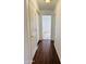 Hallway with wood-look flooring, white doors, and built-in storage cabinets for practical use at 8536 W Rockwood Dr, Peoria, AZ 85382