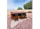 Outdoor bar setup featuring seating and a relaxed atmosphere within a red rock landscaped backyard at 8536 W Rockwood Dr, Peoria, AZ 85382