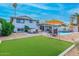 Spacious backyard with a putting green, swimming pool, and outdoor seating area at 8602 E Mitchell Dr, Scottsdale, AZ 85251