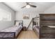 Bedroom featuring bunk beds, a ceiling fan, a large window, and a single bed at 8602 E Mitchell Dr, Scottsdale, AZ 85251