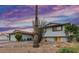 Charming home with drought-resistant landscaping, a new roof, and a tranquil atmosphere at sunset at 8602 E Mitchell Dr, Scottsdale, AZ 85251