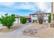 Charming home with a walkway, desert landscaping, and a vibrant red front door at 8602 E Mitchell Dr, Scottsdale, AZ 85251