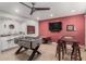 Fun game room with a foosball table, TV, and wet bar for entertaining guests at 8602 E Mitchell Dr, Scottsdale, AZ 85251