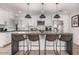 Bright, modern kitchen featuring a large island, stainless appliances, and stylish pendant lighting at 8602 E Mitchell Dr, Scottsdale, AZ 85251