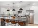 Modern kitchen with stainless steel appliances, white cabinets, and a large center island at 8602 E Mitchell Dr, Scottsdale, AZ 85251