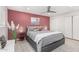 Inviting main bedroom featuring a king bed, accent wall, ceiling fan, and closet space at 8602 E Mitchell Dr, Scottsdale, AZ 85251