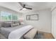 Bright main bedroom featuring neutral walls, ceiling fan, large window, and closet space at 8602 E Mitchell Dr, Scottsdale, AZ 85251