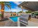 Poolside grill and bar area for outdoor entertaining at 8602 E Mitchell Dr, Scottsdale, AZ 85251