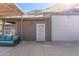 View of the backyard area featuring a covered patio, an exterior door, and an open space at 8621 W Via Montoya Dr, Peoria, AZ 85383