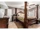 Spacious bedroom featuring unique four-poster bed, neutral walls, and tile floors at 8621 W Via Montoya Dr, Peoria, AZ 85383