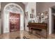 Welcoming foyer featuring a grand front door, tile flooring, and elegant decor at 8621 W Via Montoya Dr, Peoria, AZ 85383