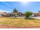 Charming single-story home featuring a well-manicured lawn and desert landscaping at 8621 W Via Montoya Dr, Peoria, AZ 85383