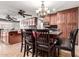 Eat-in kitchen features a dark wood table with seating and a chandelier at 8621 W Via Montoya Dr, Peoria, AZ 85383