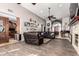 Spacious living room featuring wood tile flooring and comfortable leather furniture at 8621 W Via Montoya Dr, Peoria, AZ 85383