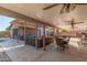 Expansive covered patio with ceiling fans and comfortable seating areas, perfect for outdoor relaxation and entertaining at 8621 W Via Montoya Dr, Peoria, AZ 85383