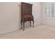 Bedroom with a vintage wooden hutch and shuttered windows providing natural light at 9214 E Diamond Dr, Sun Lakes, AZ 85248