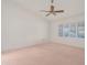 Bright bedroom featuring shuttered windows and a ceiling fan at 9214 E Diamond Dr, Sun Lakes, AZ 85248