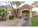 Inviting clubhouse entrance with lush landscaping and a welcoming arched doorway at 9214 E Diamond Dr, Sun Lakes, AZ 85248