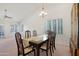 Spacious dining room with natural light, carpeted floors, and an elegant chandelier at 9214 E Diamond Dr, Sun Lakes, AZ 85248