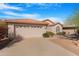 Charming single-story home featuring a two-car garage, landscaped front yard, and a beautiful red tile roof at 9214 E Diamond Dr, Sun Lakes, AZ 85248