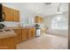 The kitchen features wood cabinets, a tile floor, and white appliances at 9214 E Diamond Dr, Sun Lakes, AZ 85248