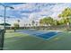 Scenic view of the blue community tennis courts, with lighting for play anytime at 9214 E Diamond Dr, Sun Lakes, AZ 85248