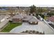 Aerial view of the expansive brick home featuring a well-manicured lawn, mature landscaping, and circular driveway at 9505 S Kenneth Pl, Tempe, AZ 85284