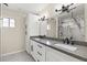 Bathroom featuring dual sinks, a large mirror, granite countertops, and modern vanity at 9505 S Kenneth Pl, Tempe, AZ 85284