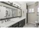 Elegant bathroom with double sinks, a large mirror, and a spacious walk-in shower at 9505 S Kenneth Pl, Tempe, AZ 85284