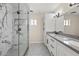 A modern bathroom featuring a marble walk-in shower and double vanity with black hardware at 9505 S Kenneth Pl, Tempe, AZ 85284