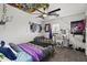 Vibrant bedroom with decorative ceiling art, a modern ceiling fan, and a comfortable bed at 9505 S Kenneth Pl, Tempe, AZ 85284