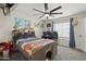 Comfortable bedroom with a ceiling fan and natural light from the window at 9505 S Kenneth Pl, Tempe, AZ 85284