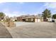 Spacious brick home featuring an expansive driveway, mature landscaping, and a two-car garage at 9505 S Kenneth Pl, Tempe, AZ 85284