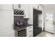 Kitchen area featuring a built-in wine rack, mini fridge, dark countertop, and stainless steel refrigerator at 9505 S Kenneth Pl, Tempe, AZ 85284