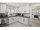 Modern kitchen showcasing white cabinetry, stainless steel appliances, sleek fixtures, and ample counter space at 9505 S Kenneth Pl, Tempe, AZ 85284