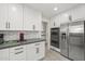 Modern kitchen featuring stainless steel appliances, hexagon backsplash, and white cabinets at 9505 S Kenneth Pl, Tempe, AZ 85284