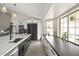 Bright kitchen featuring a large island with seating, stainless steel appliances, and an open layout at 9505 S Kenneth Pl, Tempe, AZ 85284