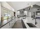 Open-concept kitchen featuring a large island, sleek appliances, modern cabinets, and views of the living space at 9505 S Kenneth Pl, Tempe, AZ 85284