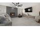 Bright living room features a fireplace, sleek floors, and a modern ceiling fan at 9505 S Kenneth Pl, Tempe, AZ 85284