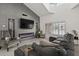 A modern living area with a fireplace, a large sofa, tile flooring, and natural light at 9505 S Kenneth Pl, Tempe, AZ 85284