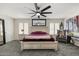 A spacious bedroom featuring a large bed, ceiling fan, plantation shutters, and a sitting area at 9505 S Kenneth Pl, Tempe, AZ 85284