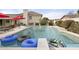 Backyard pool featuring a diving board, fountain, and nearby patio seating at 9505 S Kenneth Pl, Tempe, AZ 85284