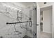 Luxurious walk-in shower featuring marble tiling, sleek fixtures, and a modern design at 9505 S Kenneth Pl, Tempe, AZ 85284