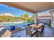 Backyard patio with a dining table, a seating area, and a pool, perfect for outdoor entertaining at 9652 E Ludlow Dr, Scottsdale, AZ 85260