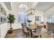 Inviting dining room with modern light fixture, large windows, and seamless flow into the adjacent living area at 9652 E Ludlow Dr, Scottsdale, AZ 85260