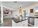 Open concept kitchen with stainless appliances, an eat-in area, and island that flows to the living room at 9652 E Ludlow Dr, Scottsdale, AZ 85260