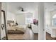 Bright main bedroom with a ceiling fan, wooden floors, a view to the bathroom, and a comfortable layout at 9652 E Ludlow Dr, Scottsdale, AZ 85260