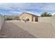 This spacious backyard offers a hot tub, patio seating, and desert landscaping, perfect for outdoor relaxation at 10323 W Carousel Dr, Arizona City, AZ 85123